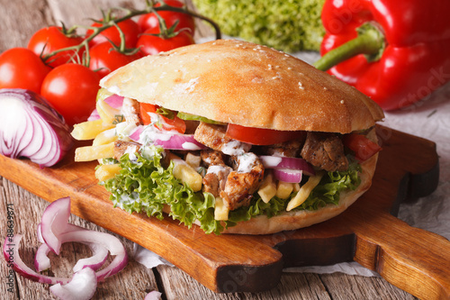 Doner kebab with meat, vegetables and french fries closeup. horizontal
