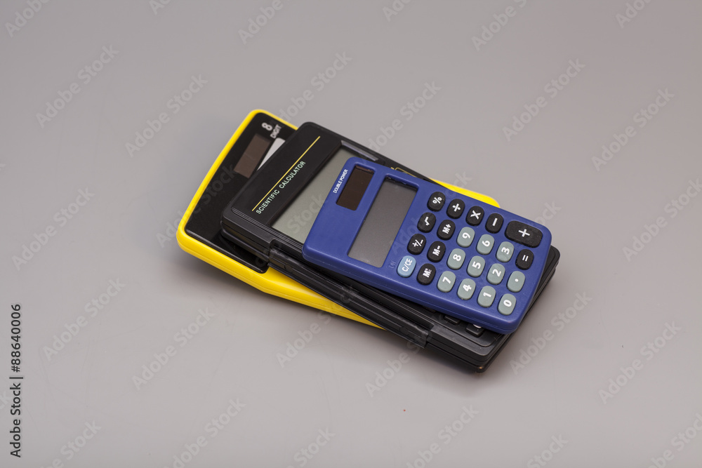 three calculators isolated on gray background three calculators isolated on gray background