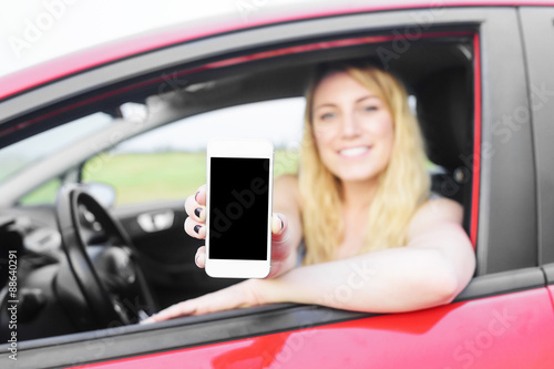 Driver woman showing her smartphone.
