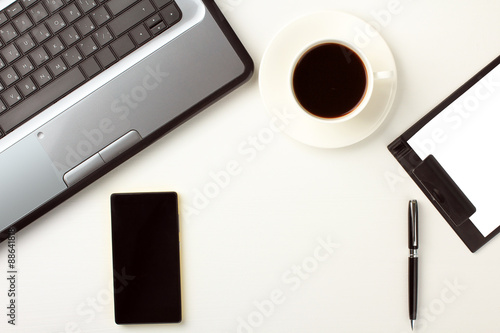 white background, laptop, phone, cup, pen, paper holder