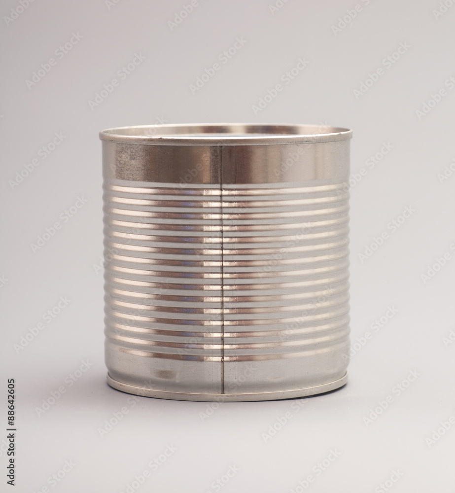 A silver tin can isolated on a gray background A silver tin can isolated on a gray background