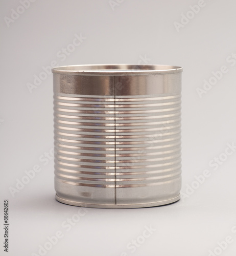 A silver tin can isolated on a gray background