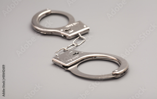 Handcuffs isolated on gray background