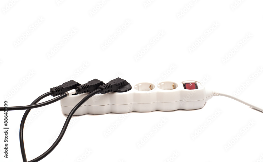 Many plugs plugged into electric power bar isolated on white Stock