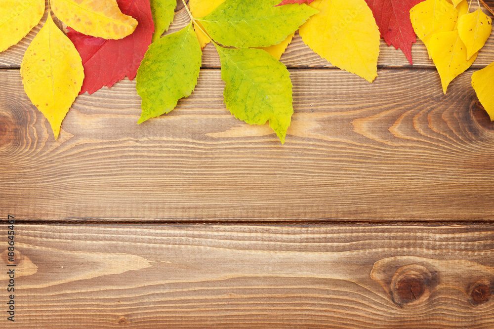 Autumn leaves over wood background with copy space Autumn leaves over wood background with copy space