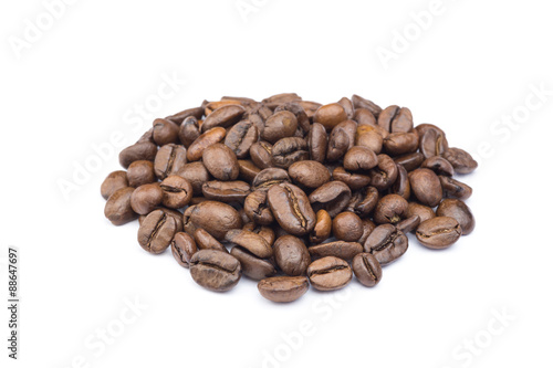 Heap of whole coffee beans isolated on white background