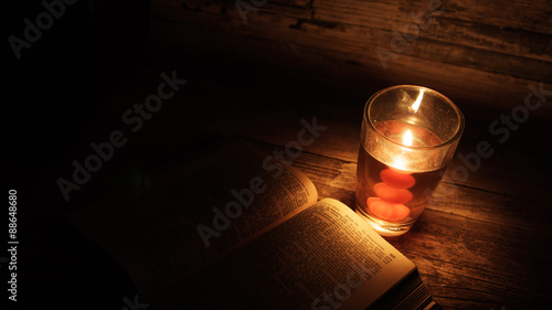 Candle and a Book with Vintage Background