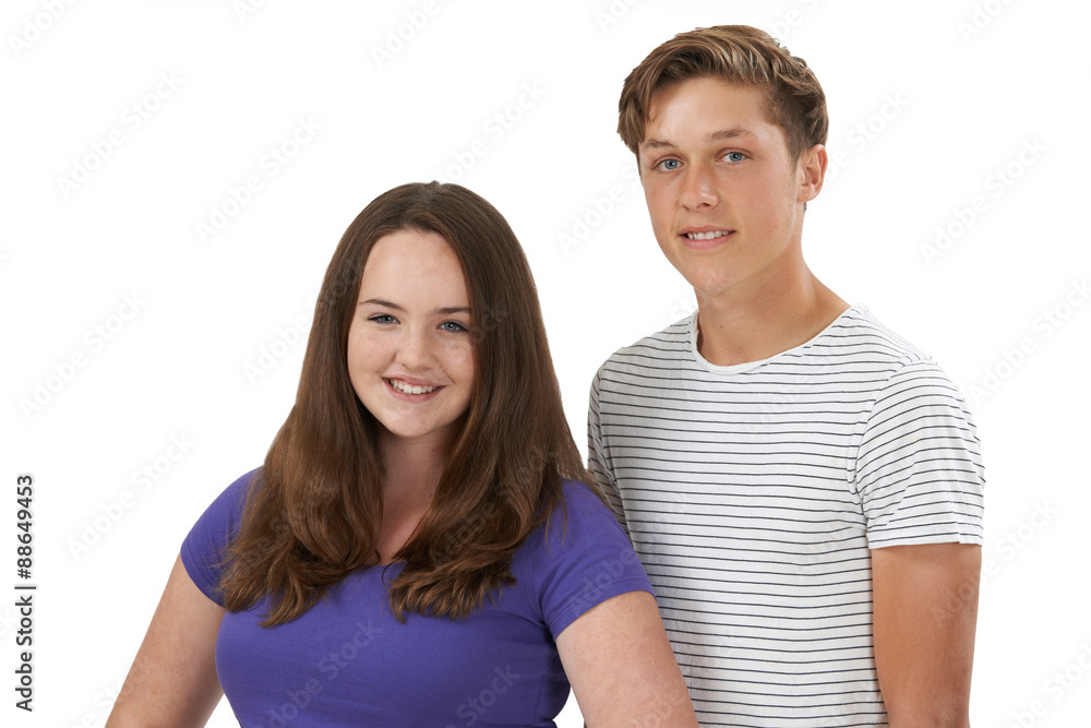 Studio Portrait Of Teenage Couple Against White Background Studio Portrait Of Teenage Couple Against White Background