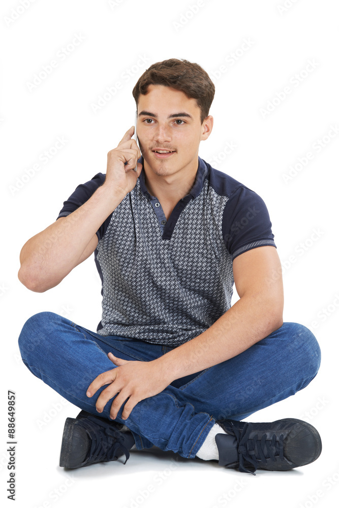 Studio Portrait Of Teenage Boy Talking On Mobile Phone Studio Portrait Of Teenage Boy Talking On Mobile Phone