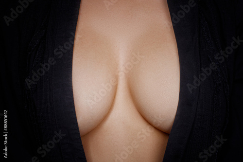 Topless woman body covering her big breast 