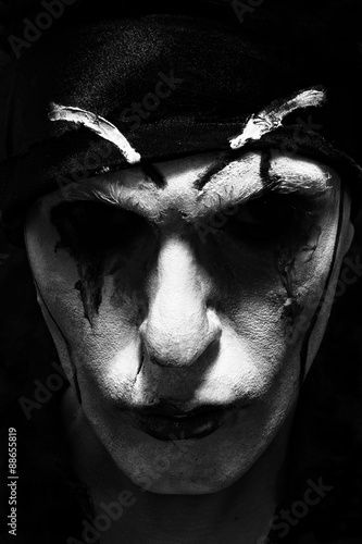theatrical actor with dark makeup on her face