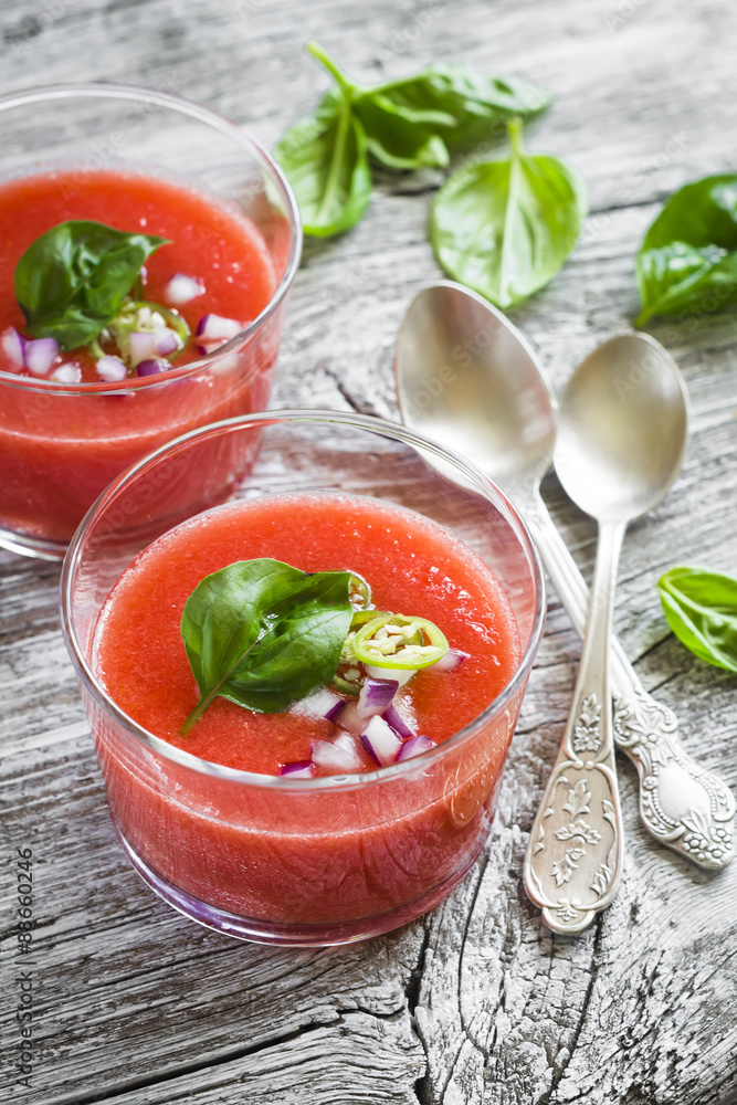 gazpacho in a glass bowl on a light wooden background gazpacho in a glass bowl on a light wooden background
