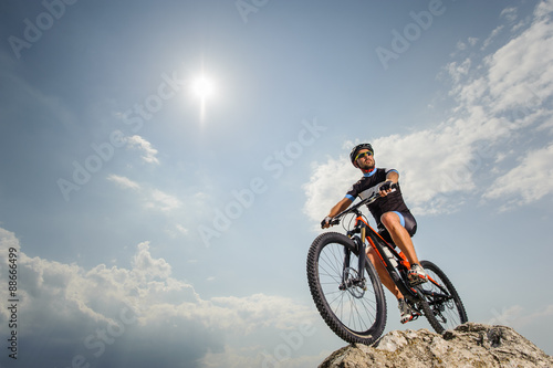 the guy with the bike on top of the mountain