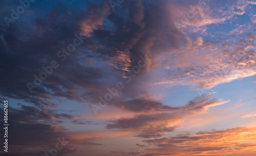 Dramatic sunset sky with orange colored clouds.