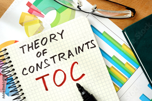 Words Theory of Constraints  TOC   on the notepad and charts. photo
