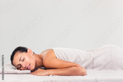 Pretty woman resting on massage lounger