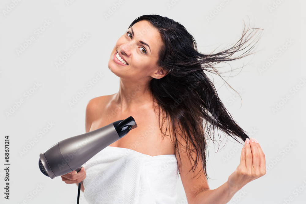 Smiling woman in towel drying her hair Smiling woman in towel drying her hair
