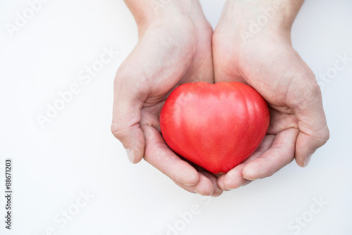 Fototapeta Naklejka Na Ścianę i Meble -  Tomato heart in the hands isolated