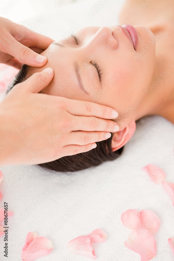 Attractive young woman receiving facial massage Attractive young woman receiving facial massage