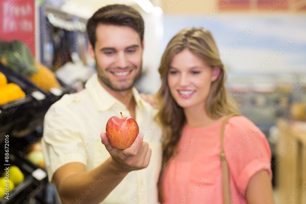 Fototapeta premium Smiling bright couple buying food products