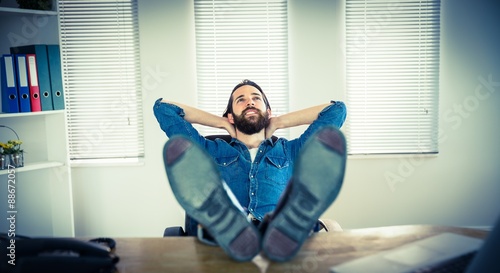 Hipster businessman relaxing at his desk