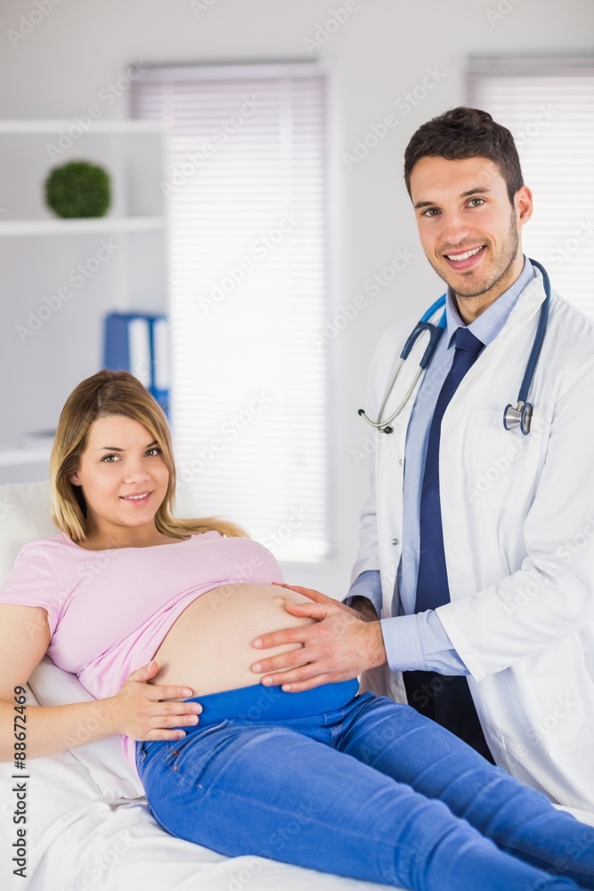 Portrait of smiling doctor and his pregnant patient Portrait of smiling doctor and his pregnant patient