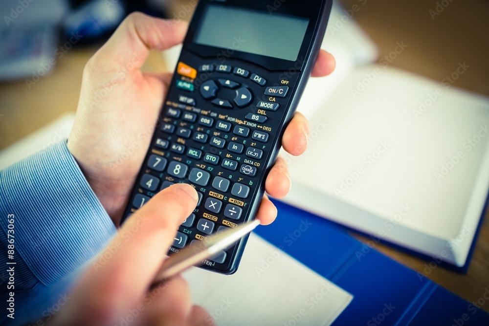 Businessman hands typing on calculator Businessman hands typing on calculator
