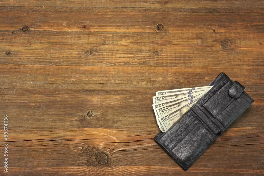 Men's Wallet With Dollar Cash On The Rough Wood Background