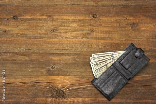 Men's Wallet With Dollar Cash On The Rough Wood Background
