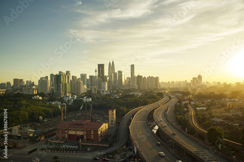 Dramatic scenery of elevated highway heading towards Kuala Lumpur city centre during sunset.