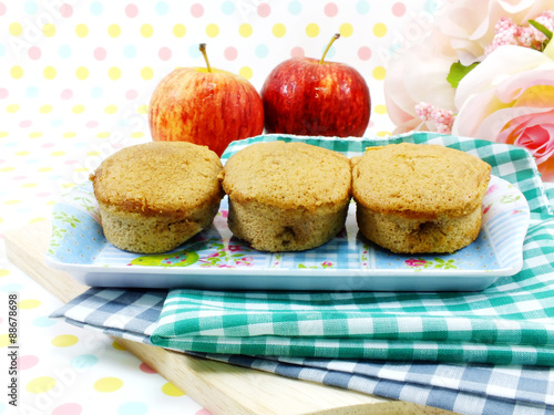 egg cake coffee flavor and red apple on sweet polka dot background photo