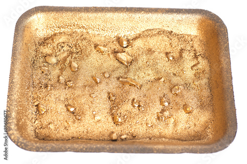 Tableau sur toile Golden nuggets on grungy wash pan with sand isolated
