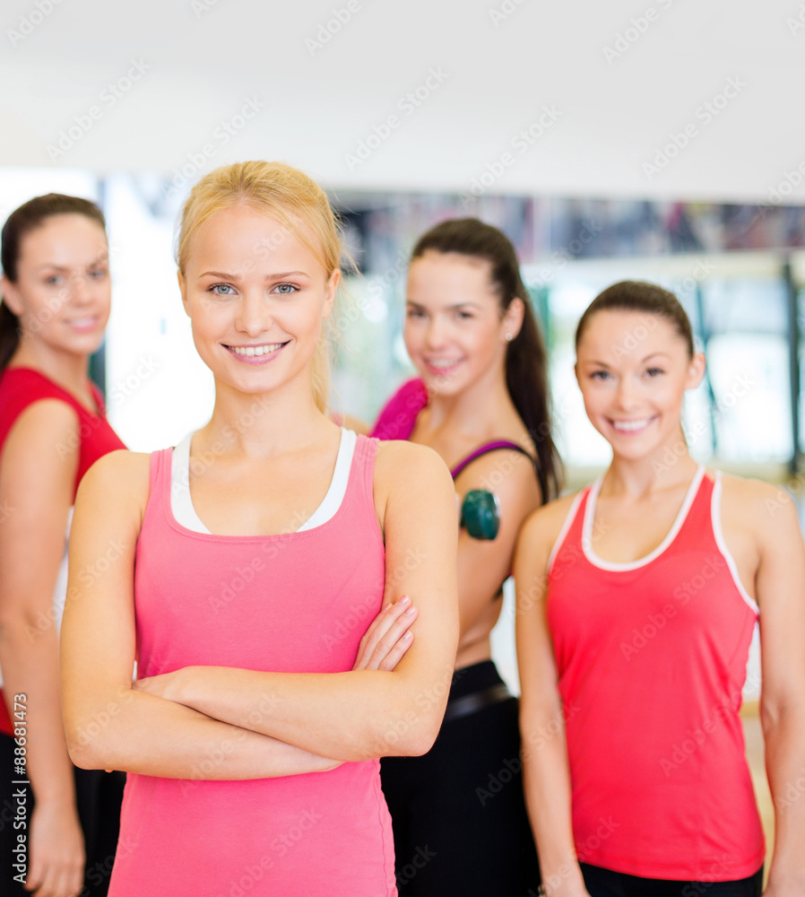 woman standing in front of the group in gym woman standing in front of the group in gym
