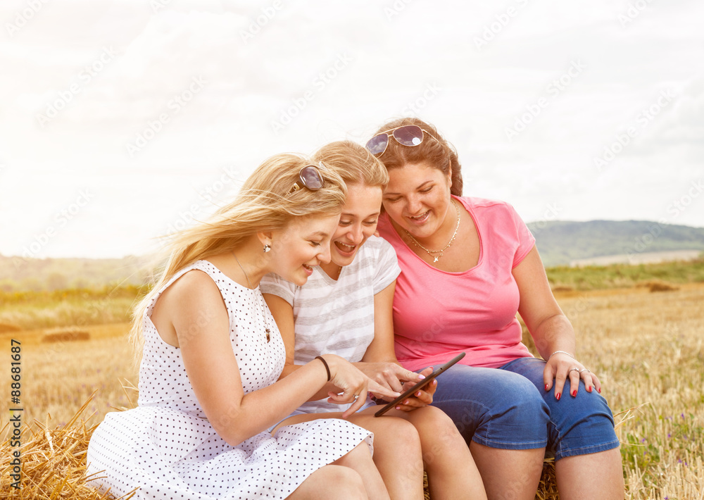 Group of friends outdoors with a tablet