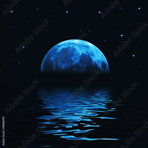 Big blue moon reflected in water