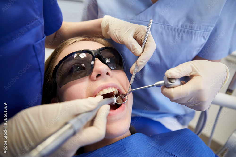 female dentists treating patient girl teeth female dentists treating patient girl teeth