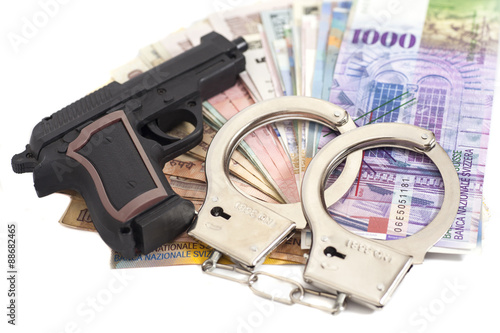 Gun, handcuffs and money isolated on white background