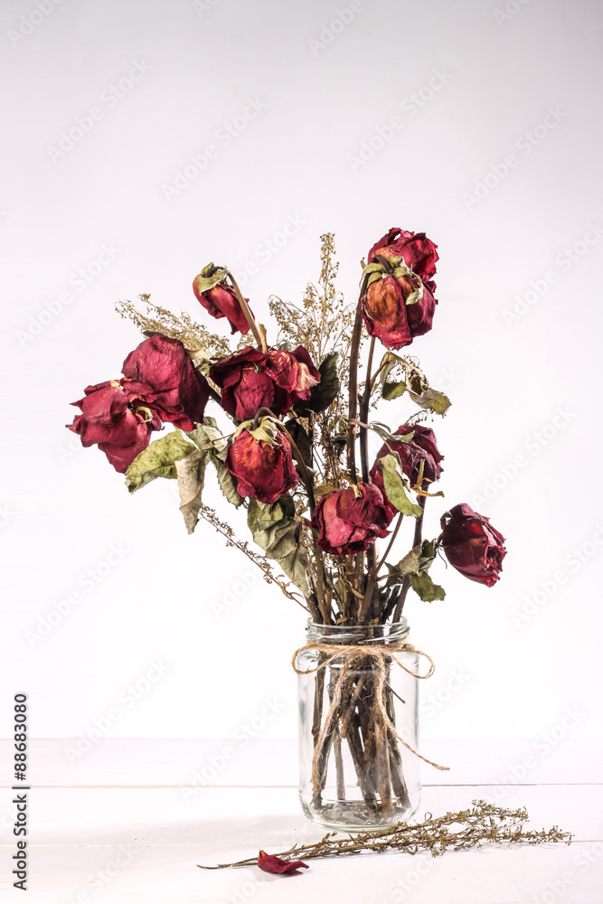 Obraz premium dried roses in glass vase