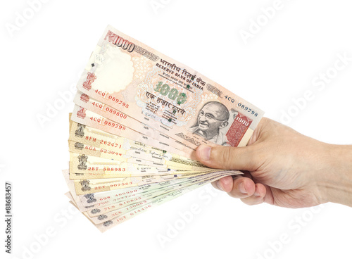 Hand with Indian thousand rupee notes
