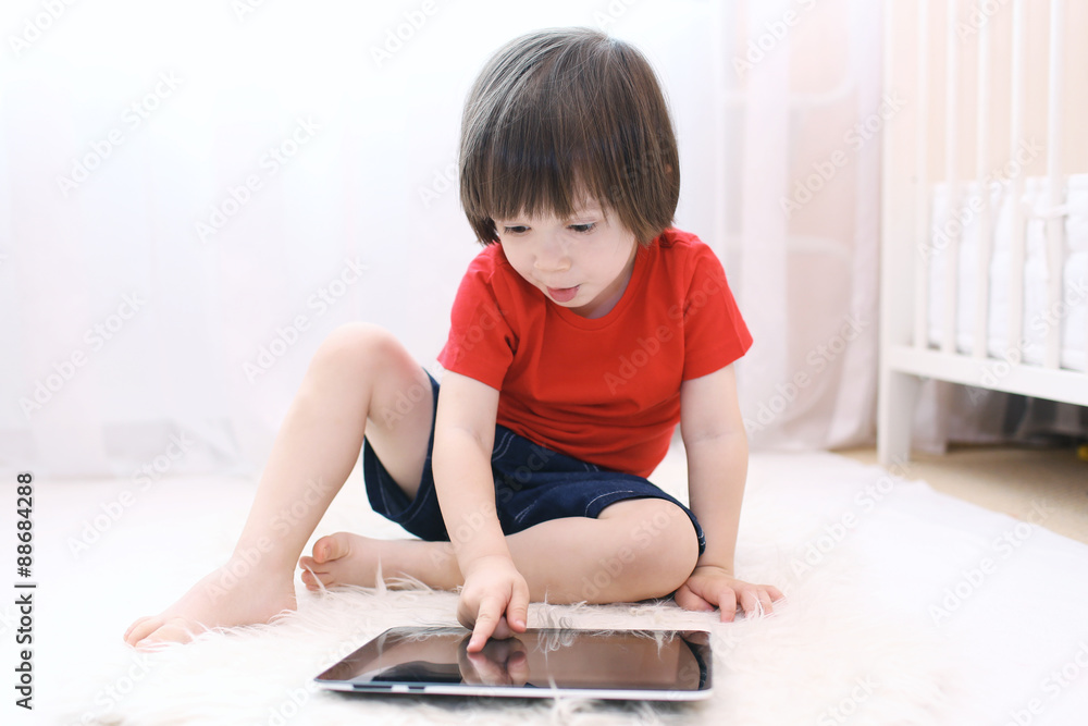 Cute child with tablet computer at home Cute child with tablet computer at home
