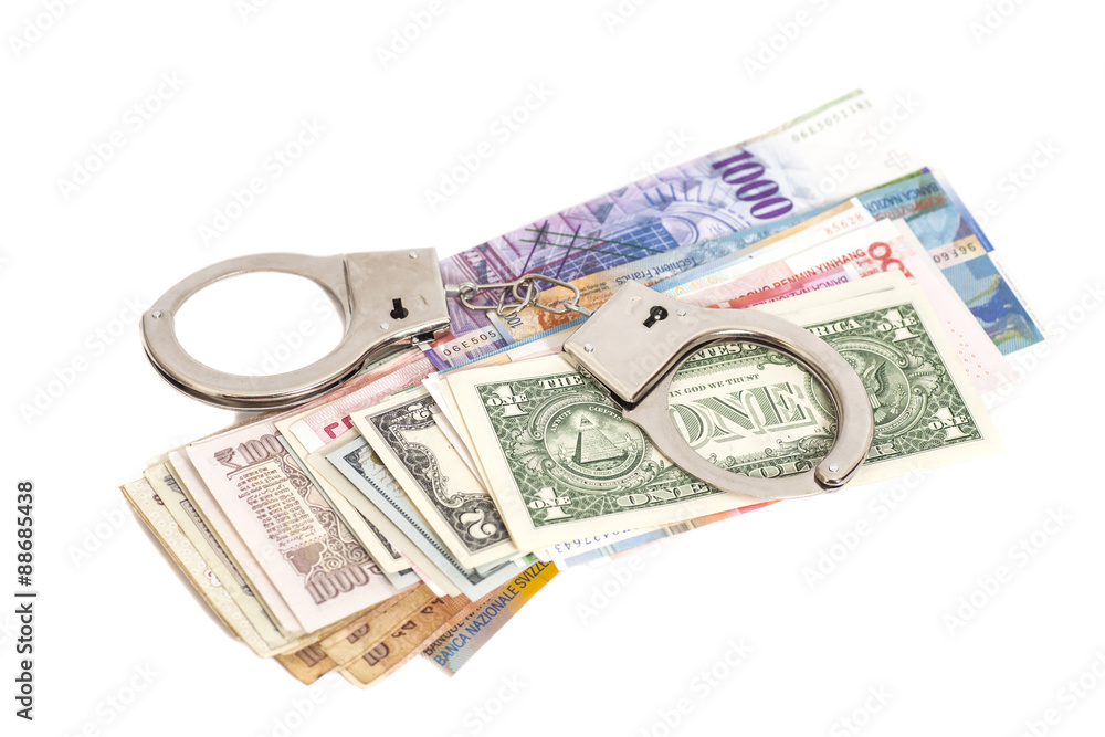 handcuffs and money isolated on white background handcuffs and money isolated on white background