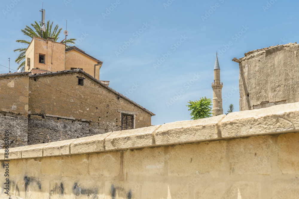 Walls around the old town of the Turkish section of Nicosia, Cyprus with a minaret tower of a mosque in the background.