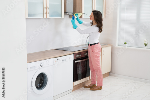Woman Cleaning Cooker Hood
