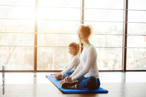 Two girls of different ages makeing yoga