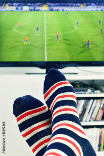 man watching a soccer match in the TV