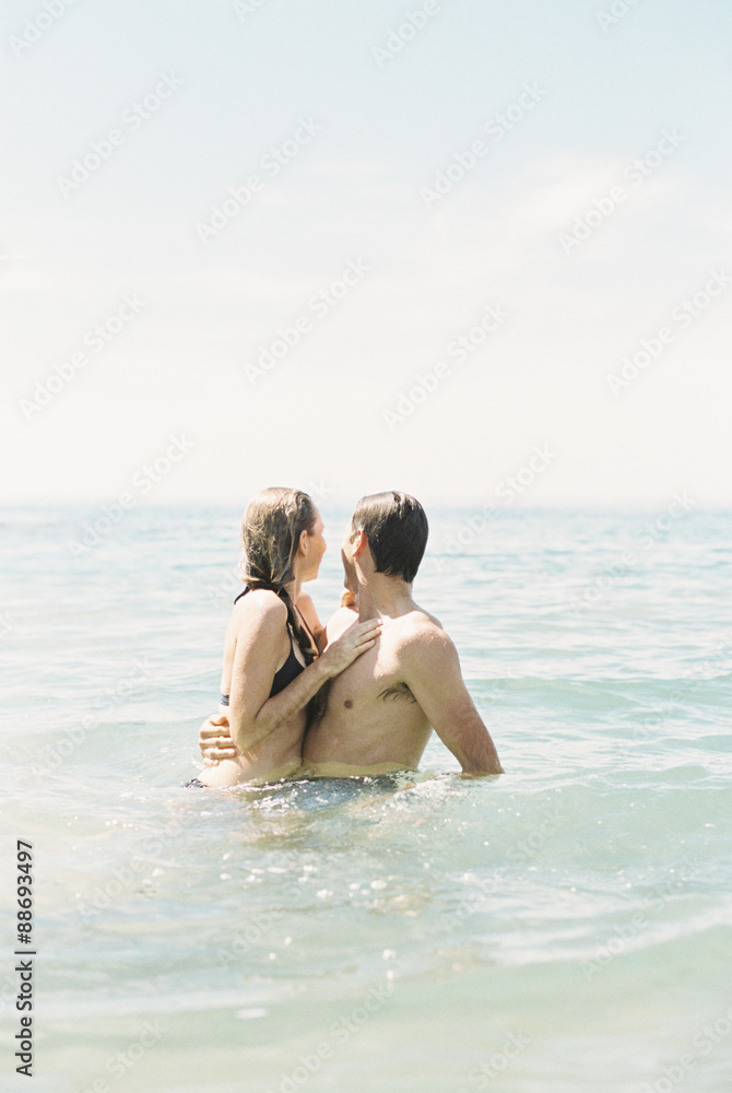 Couple hugging each other, in waist deep water. Couple hugging each other, in waist deep water.