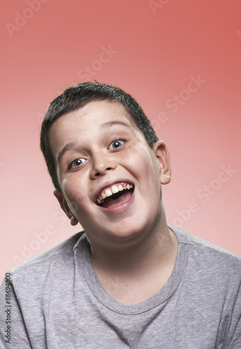 Hilarious smiling portrait of young kid