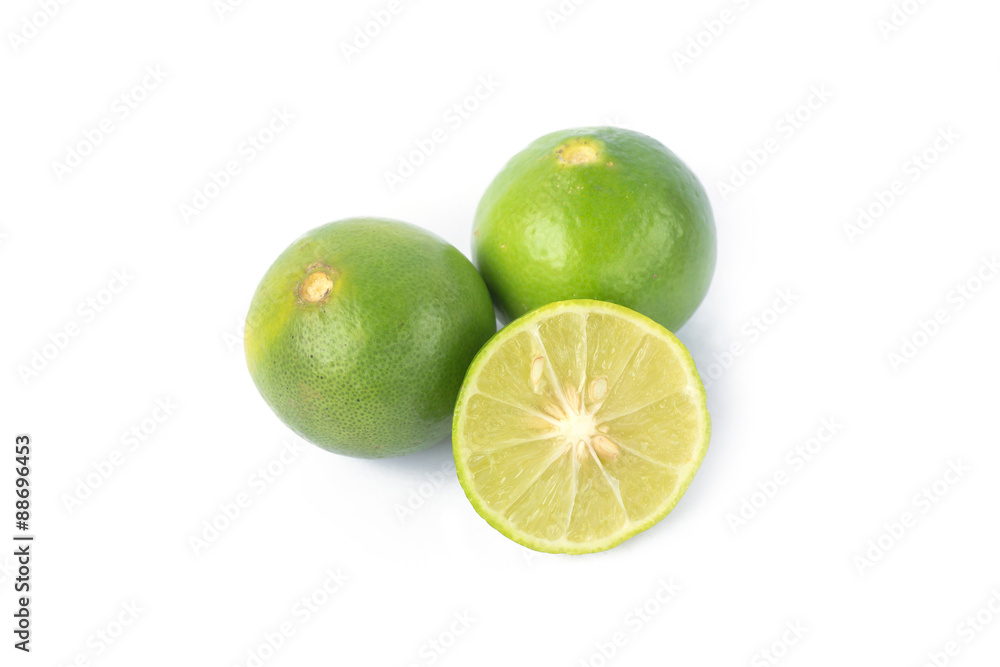 Green lemons on white background