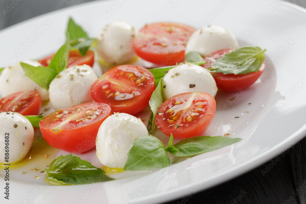 caprese salad with mini mozzarella balls and tomatoes caprese salad with mini mozzarella balls and tomatoes