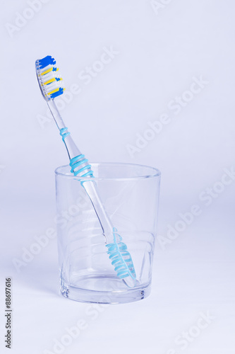 Single toothbrush in glass